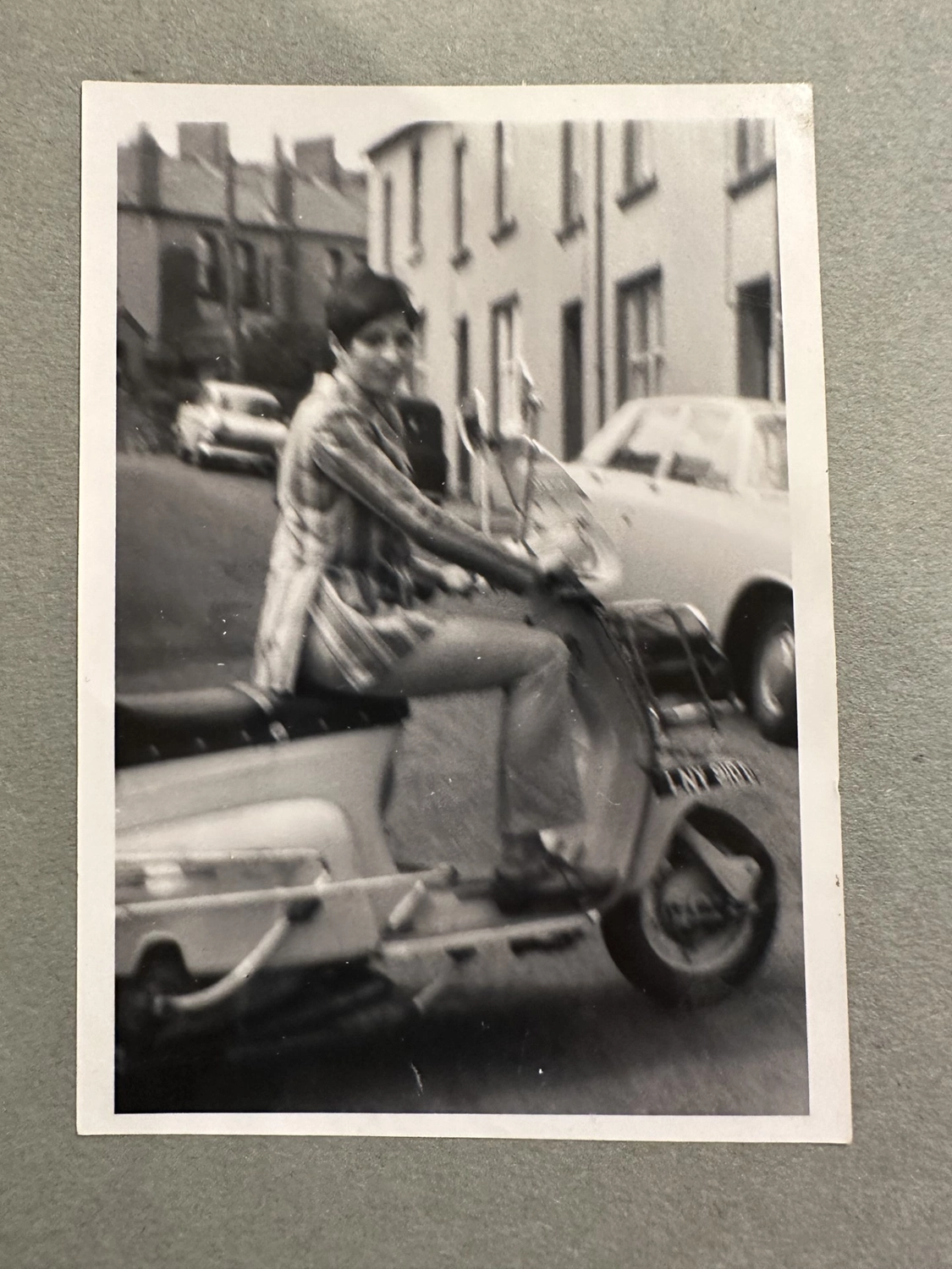 Vintage snapshot of Rosemary, Anna's mum, riding her scooter along a terraced street, inspiration for Ffin MOD