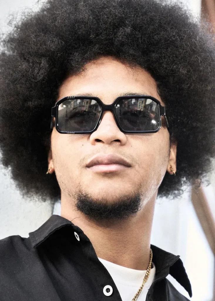 Man with a full afro in black square Ffin BOD designer sunglasses