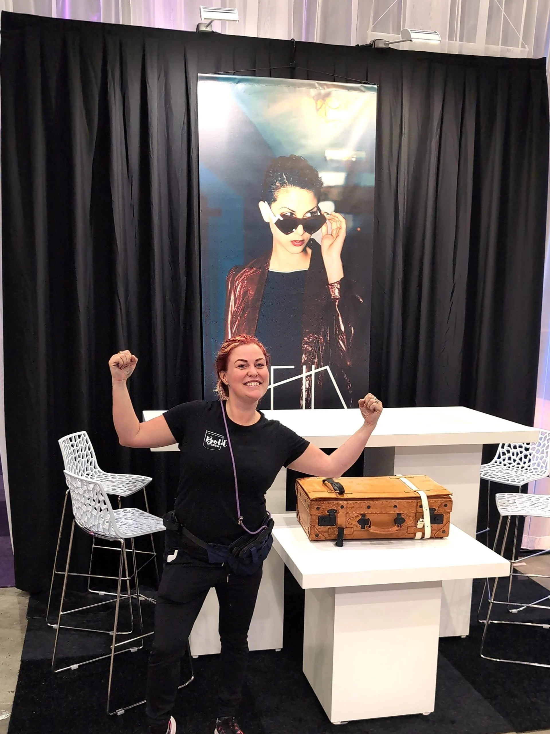 Ffin team member celebrating with raised fists at the Ffin stand at Bold XXL