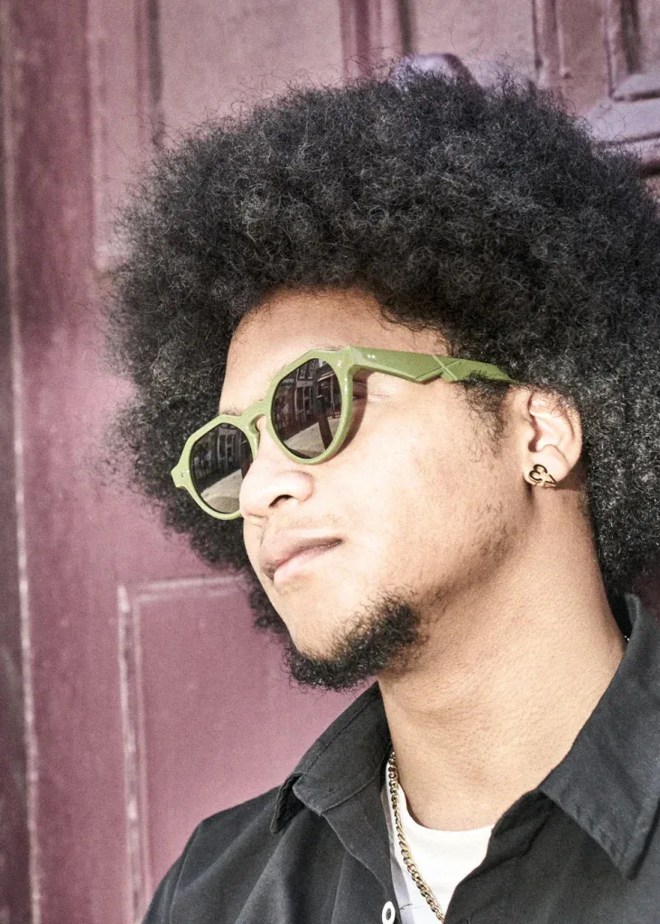 Man with an afro in olive green Ffin NON designer sunglasses