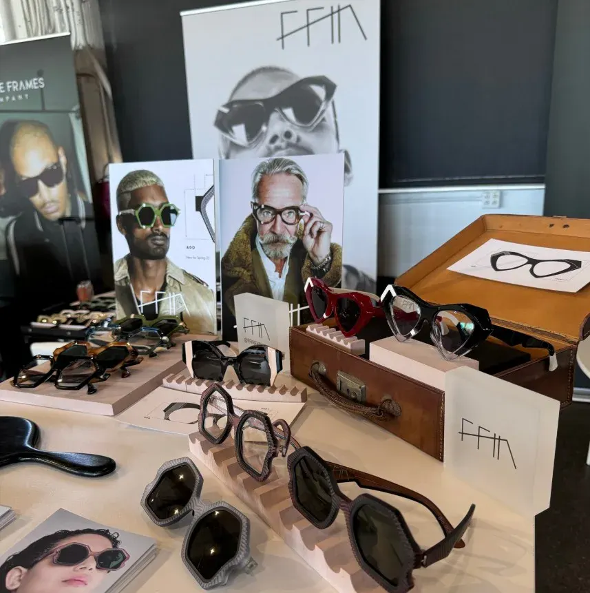 Ffin stand at LOFT San Francisco with designer sunglasses and optical frames beside portrait prints