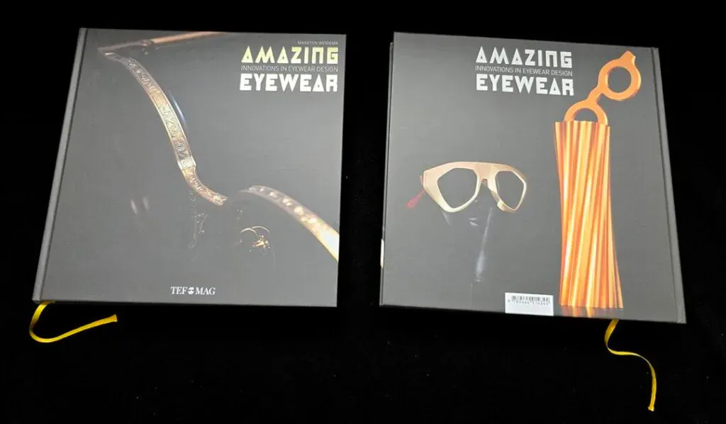 Two copies of the Amazing Eyewear Volume 2 book, which features Ffin Eyewear