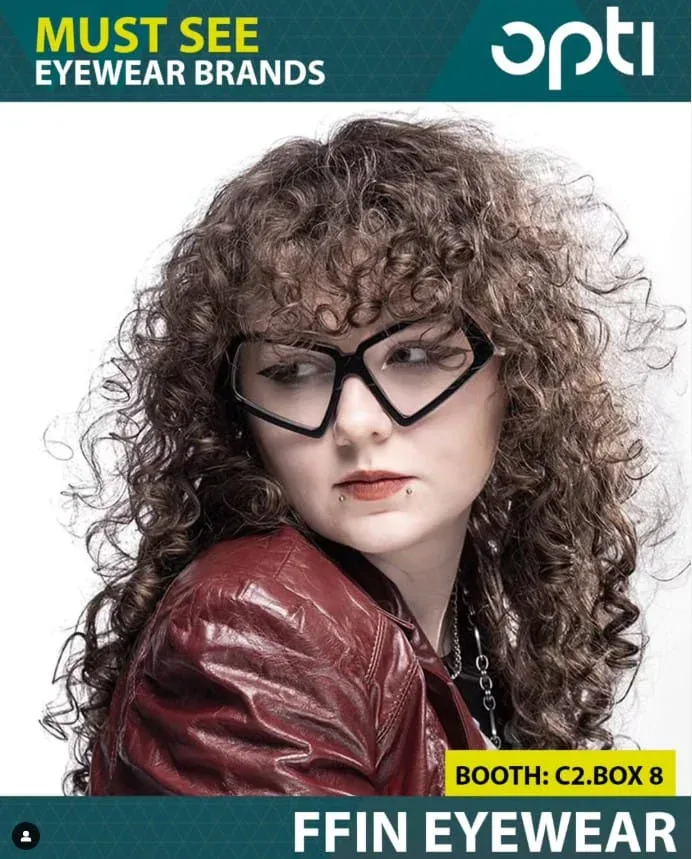 OPTI Munich "Must see eyewear brands" advert: model with curly hair in black angular Ffin optical frames