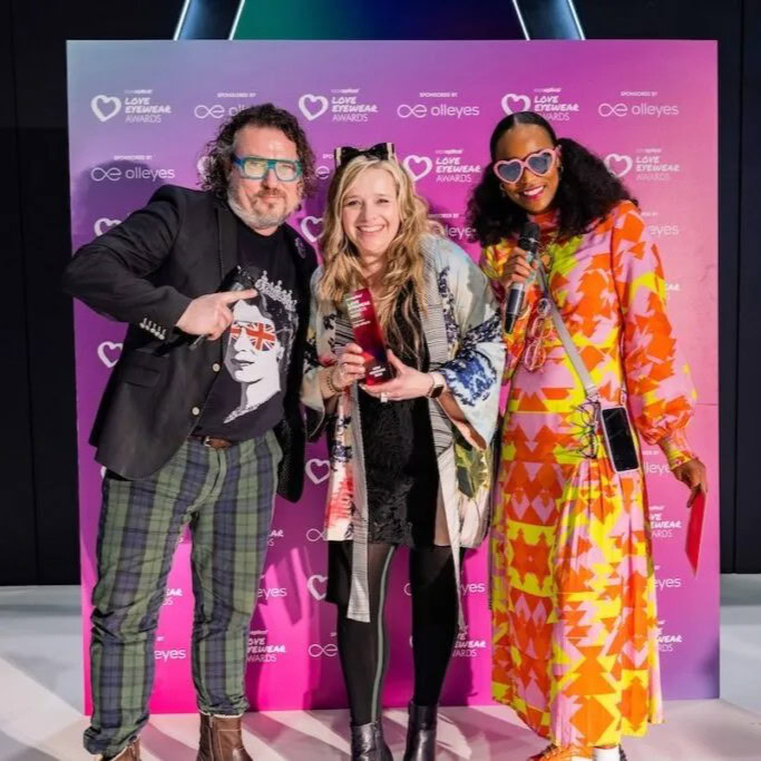 Ffin Eyewear team holding trophies at the Love Eyewear Awards, celebrating two wins at 100% Optical
