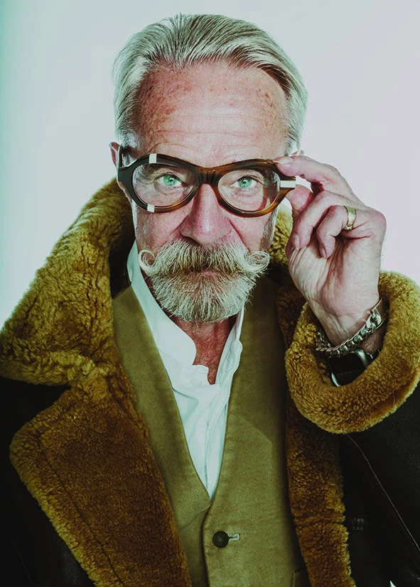 Man with a white moustache and a shearling collar adjusting tortoiseshell Ffin ANA optical frames