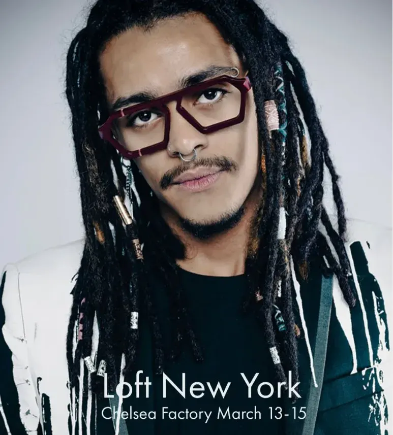 Model with long locs in burgundy angular Ffin optical frames, promoting Ffin at LOFT New York