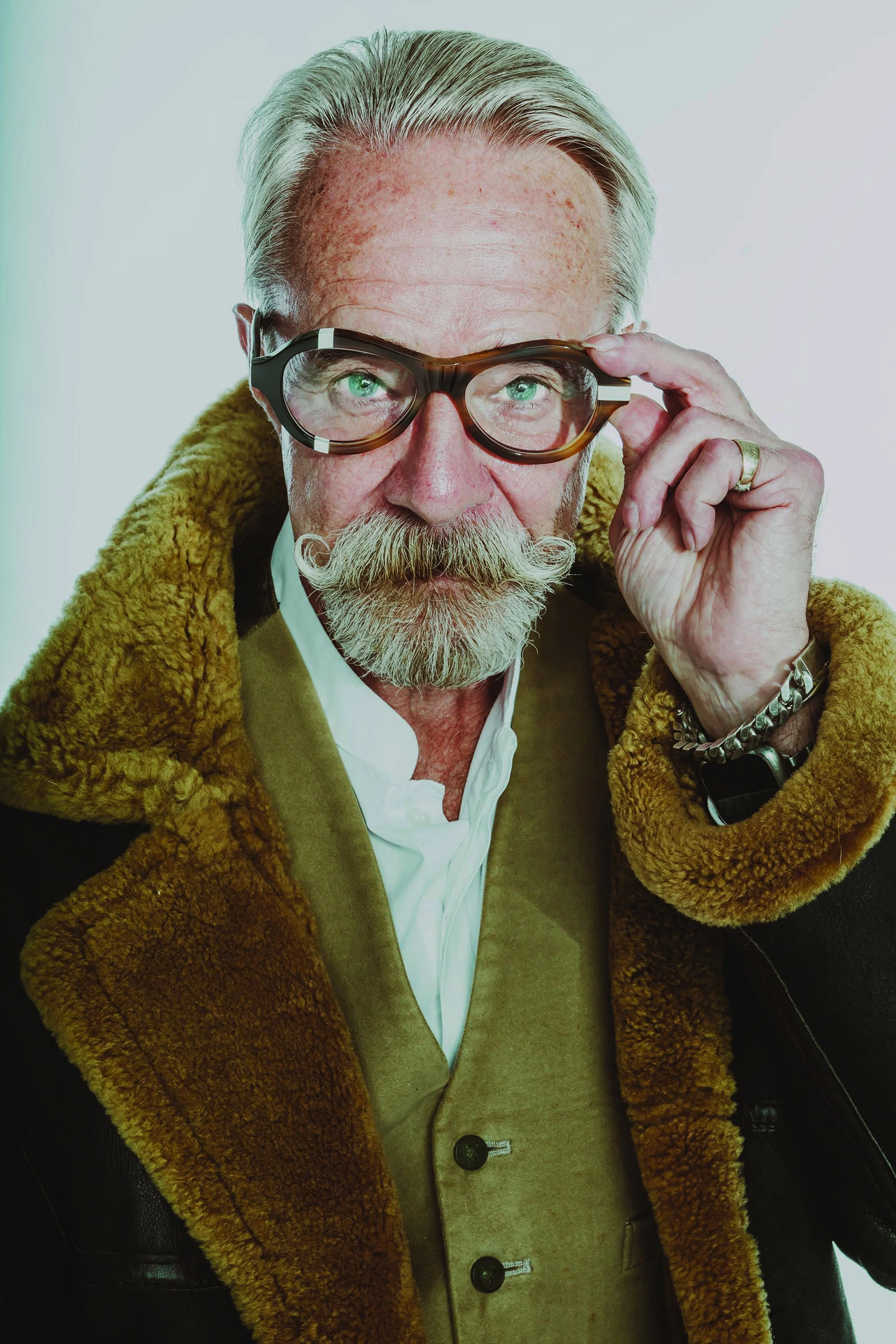 Gary in tortoiseshell Ffin ANA award-winning optical frames and a shearling collar, adjusting the frames