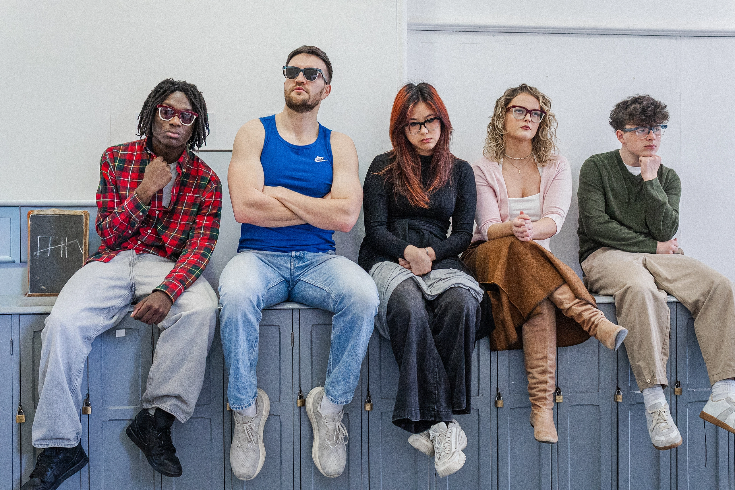 Five models sitting on school lockers wearing Ffin GEN eyewear, a Breakfast Club homage