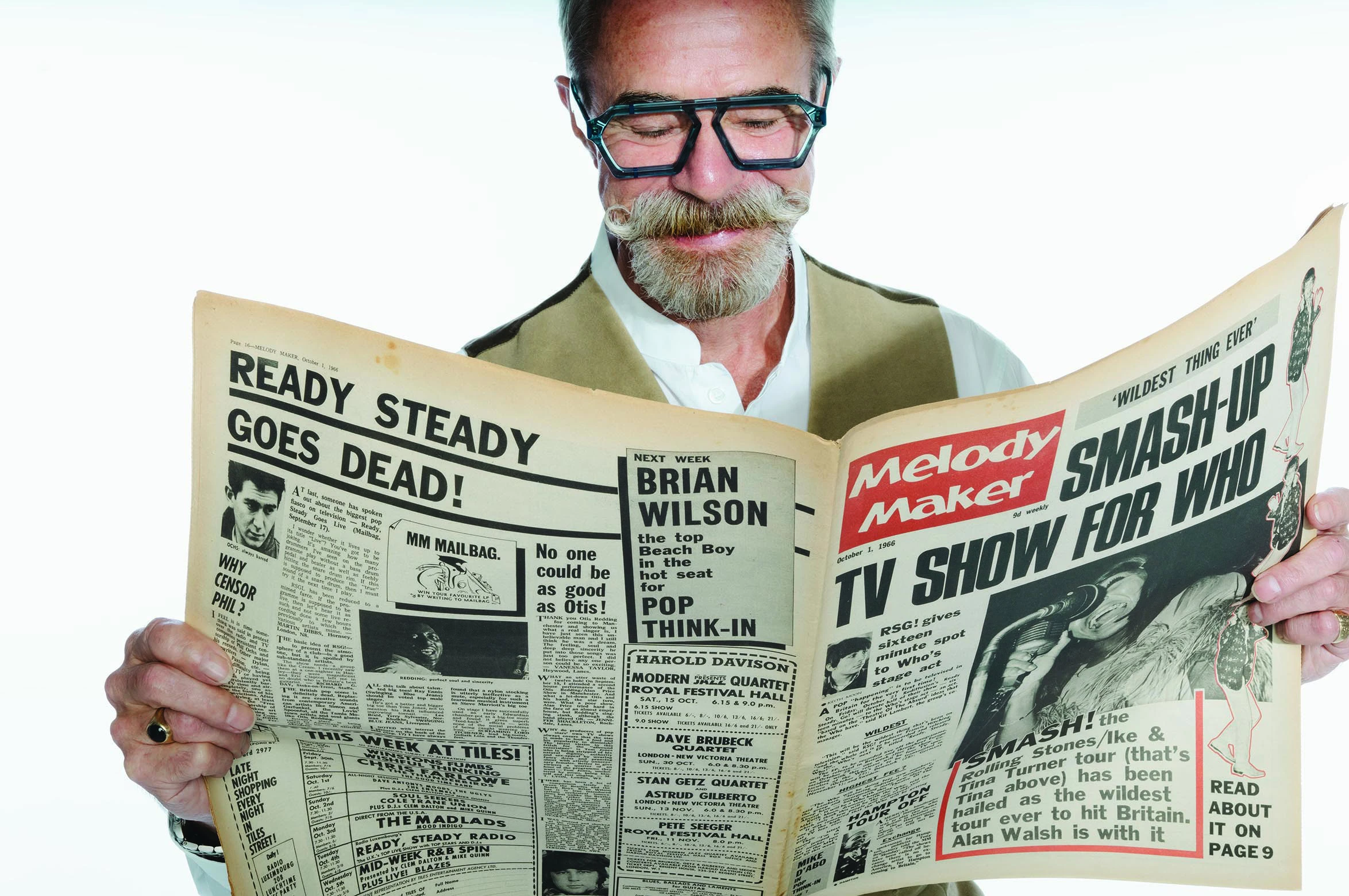 Gary in blue Ffin ERA optical frames reading a vintage Melody Maker newspaper