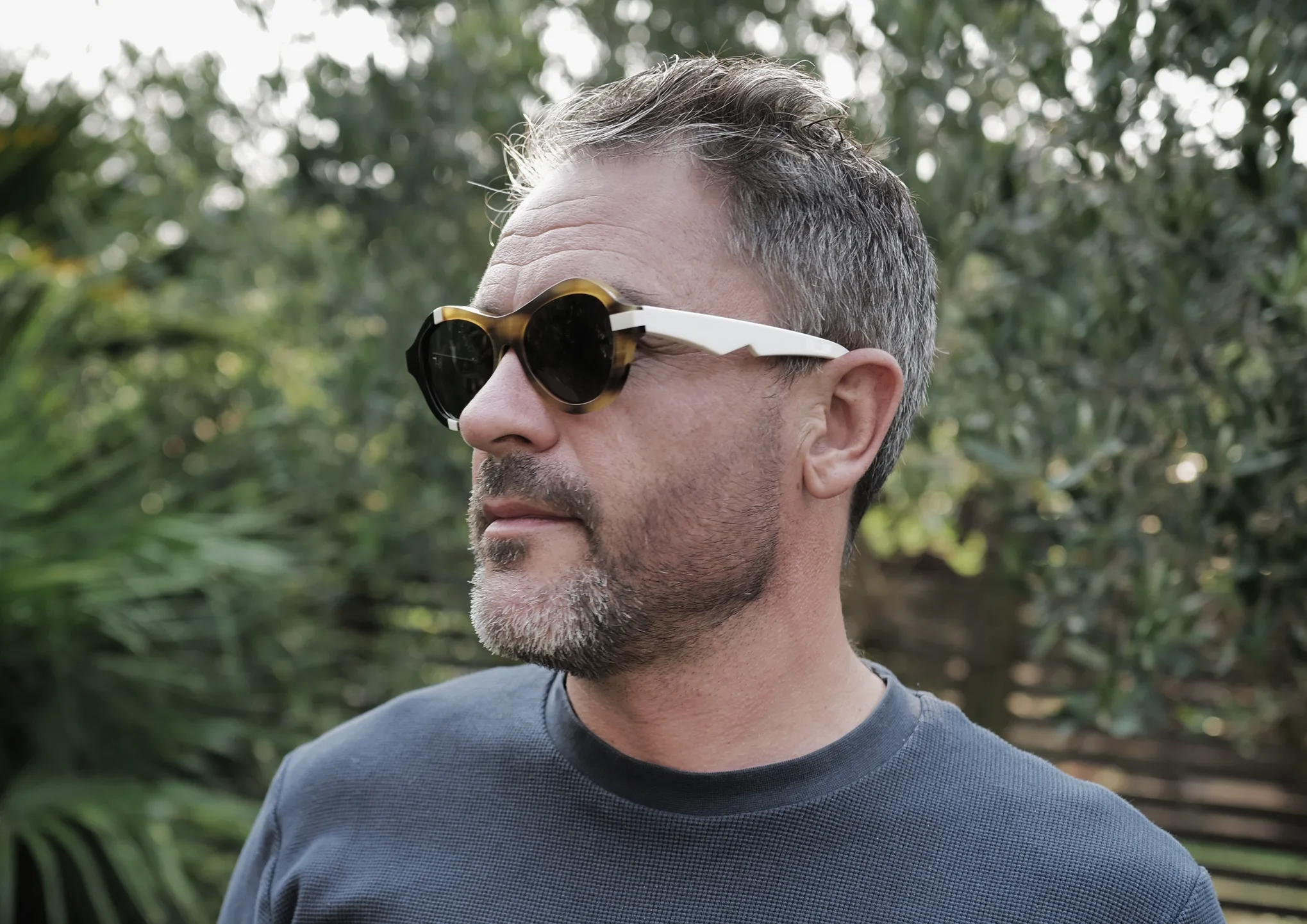 Explorer Levison Wood in tortoiseshell Ffin ANA designer sunglasses with white temples, looking aside