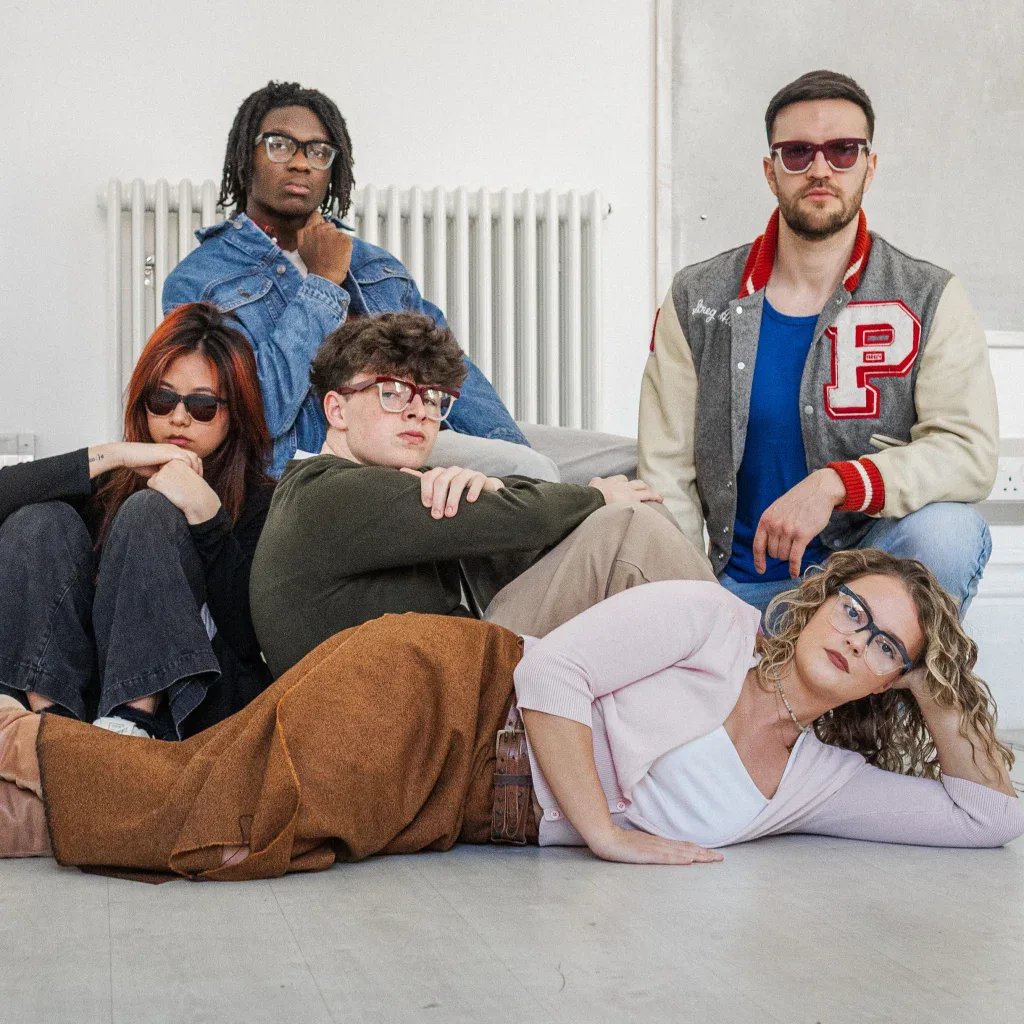 Five models posed on a floor in Ffin GEN eyewear, a Breakfast Club homage