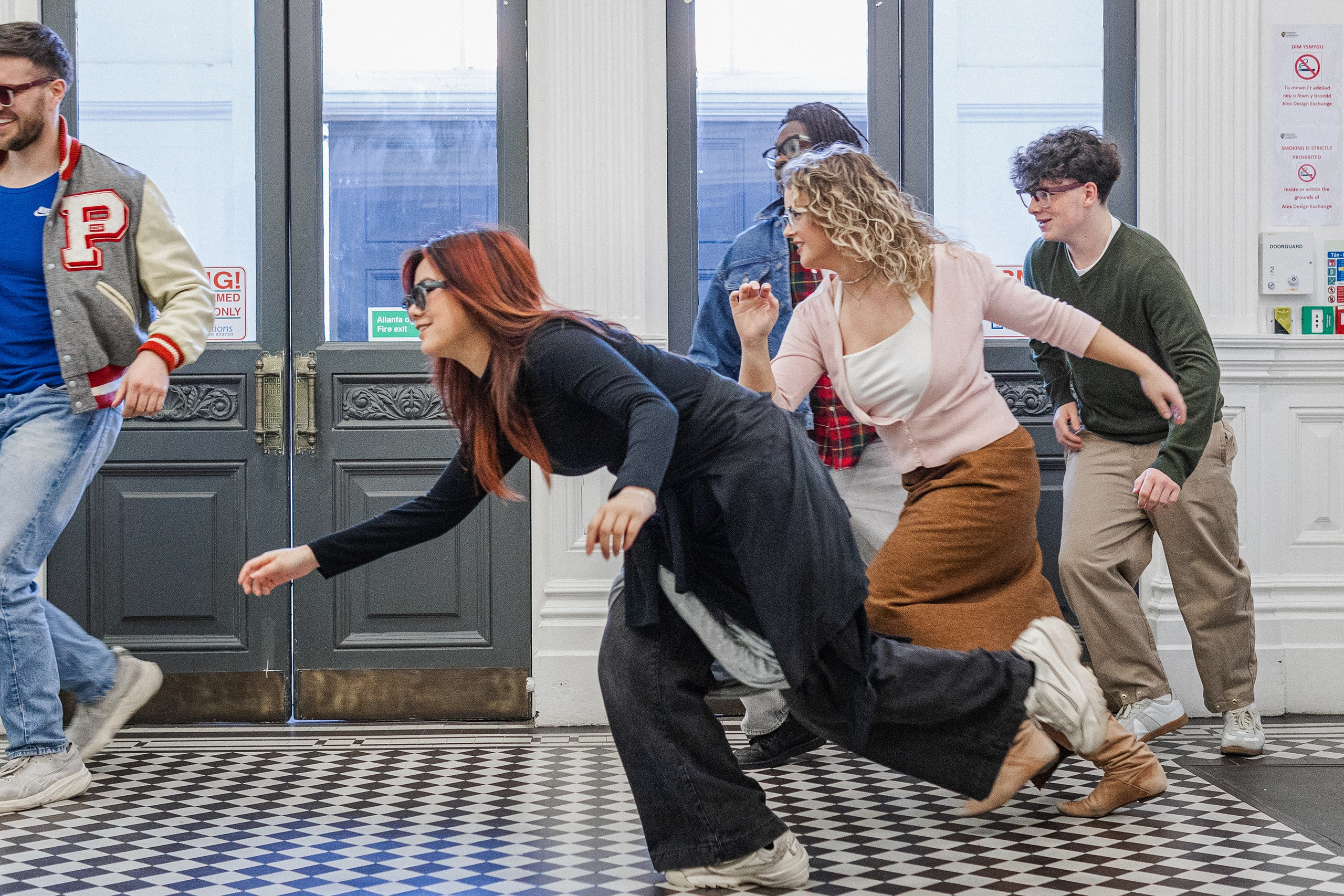 Models running through a tiled hallway in Ffin GEN eyewear, Breakfast Club shoot