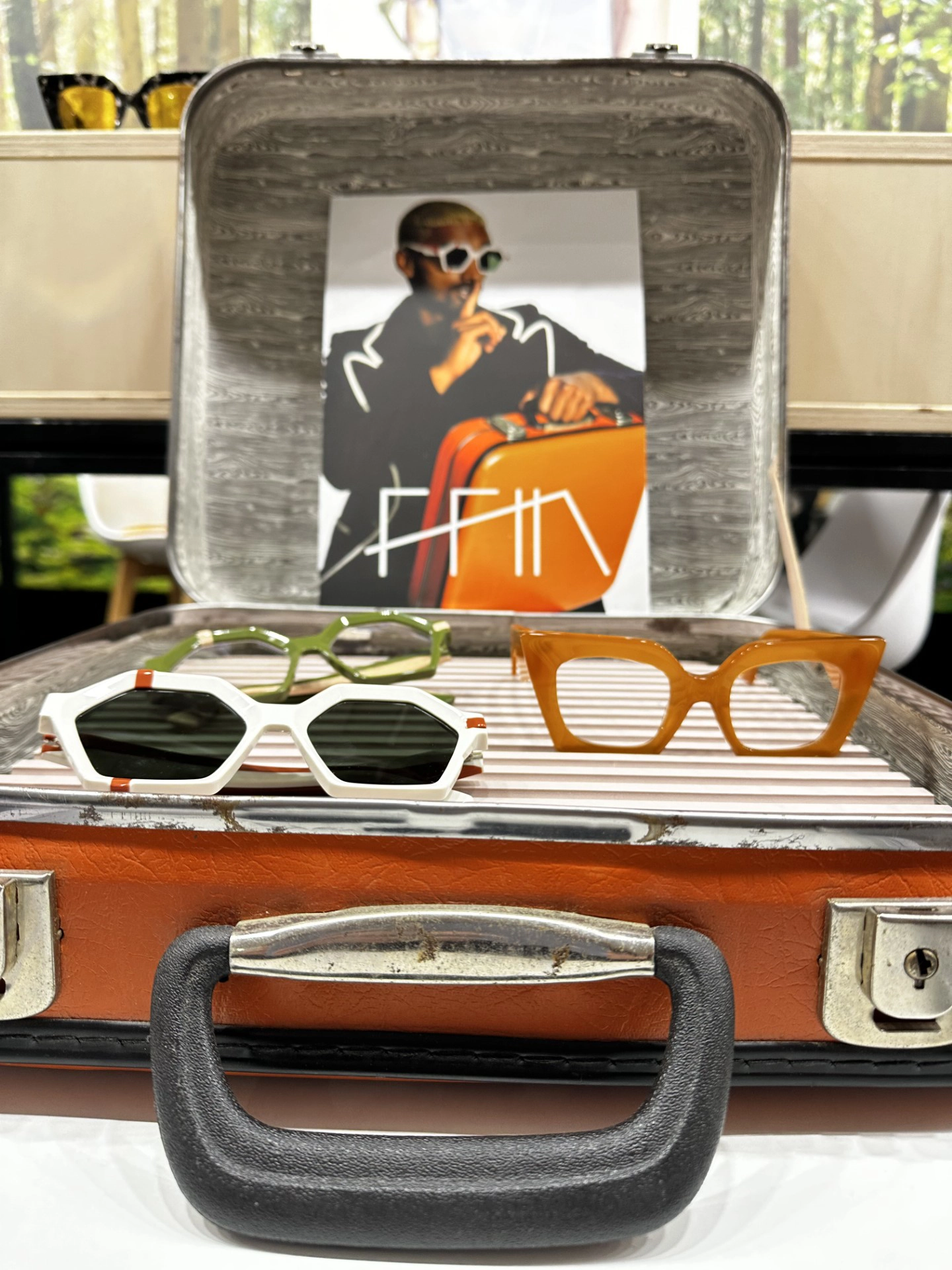 Orange vintage suitcase display of Ffin designer sunglasses at the MIDO stand