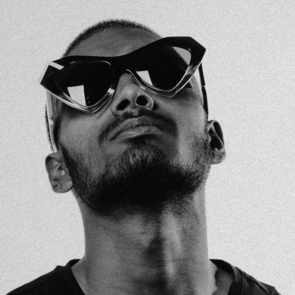 Black and white low-angle portrait of a bearded man in angular black Ffin NOS designer sunglasses