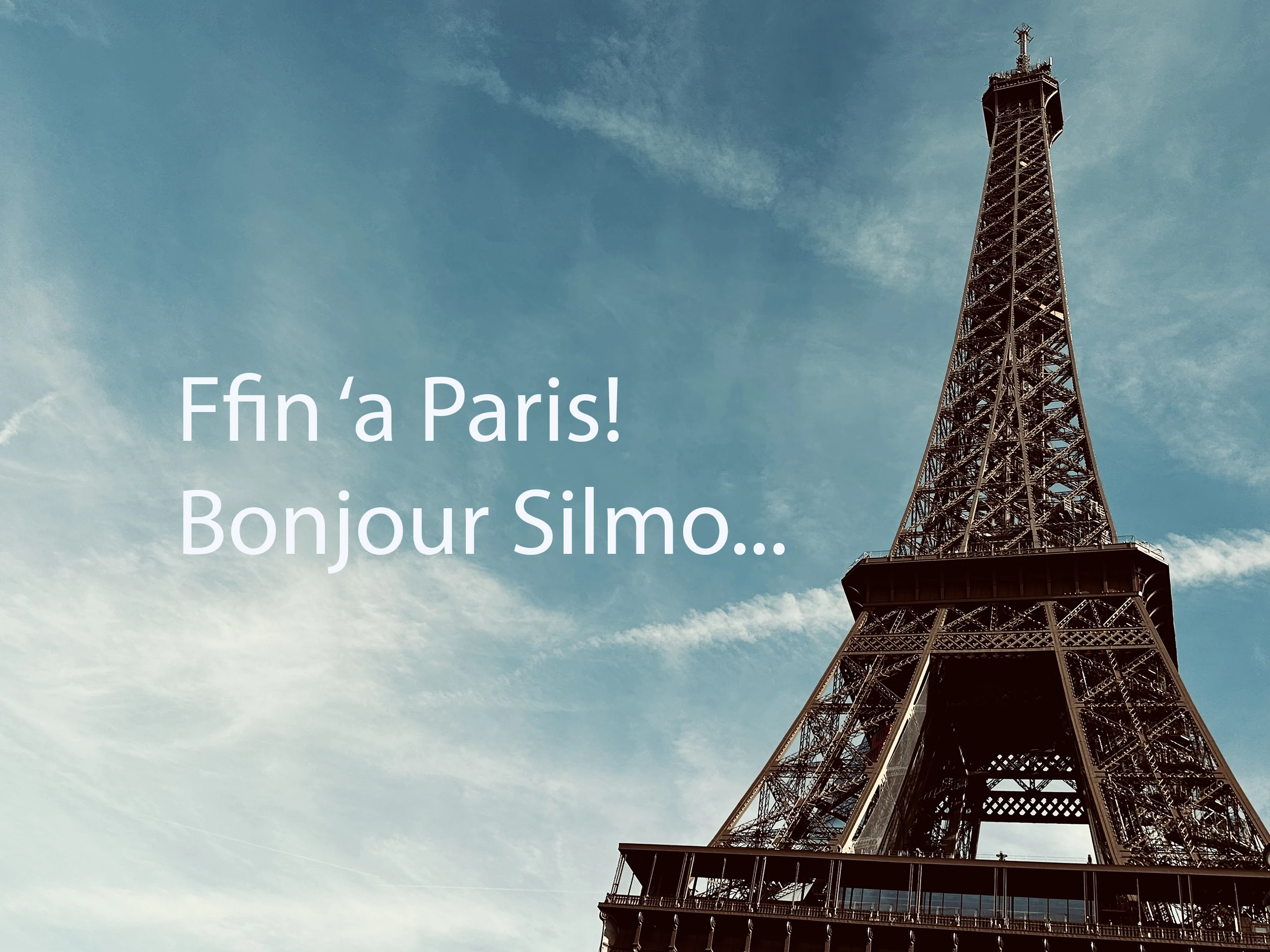 Eiffel Tower against a blue sky with the greeting "Ffin 'a Paris! Bonjour Silmo..."