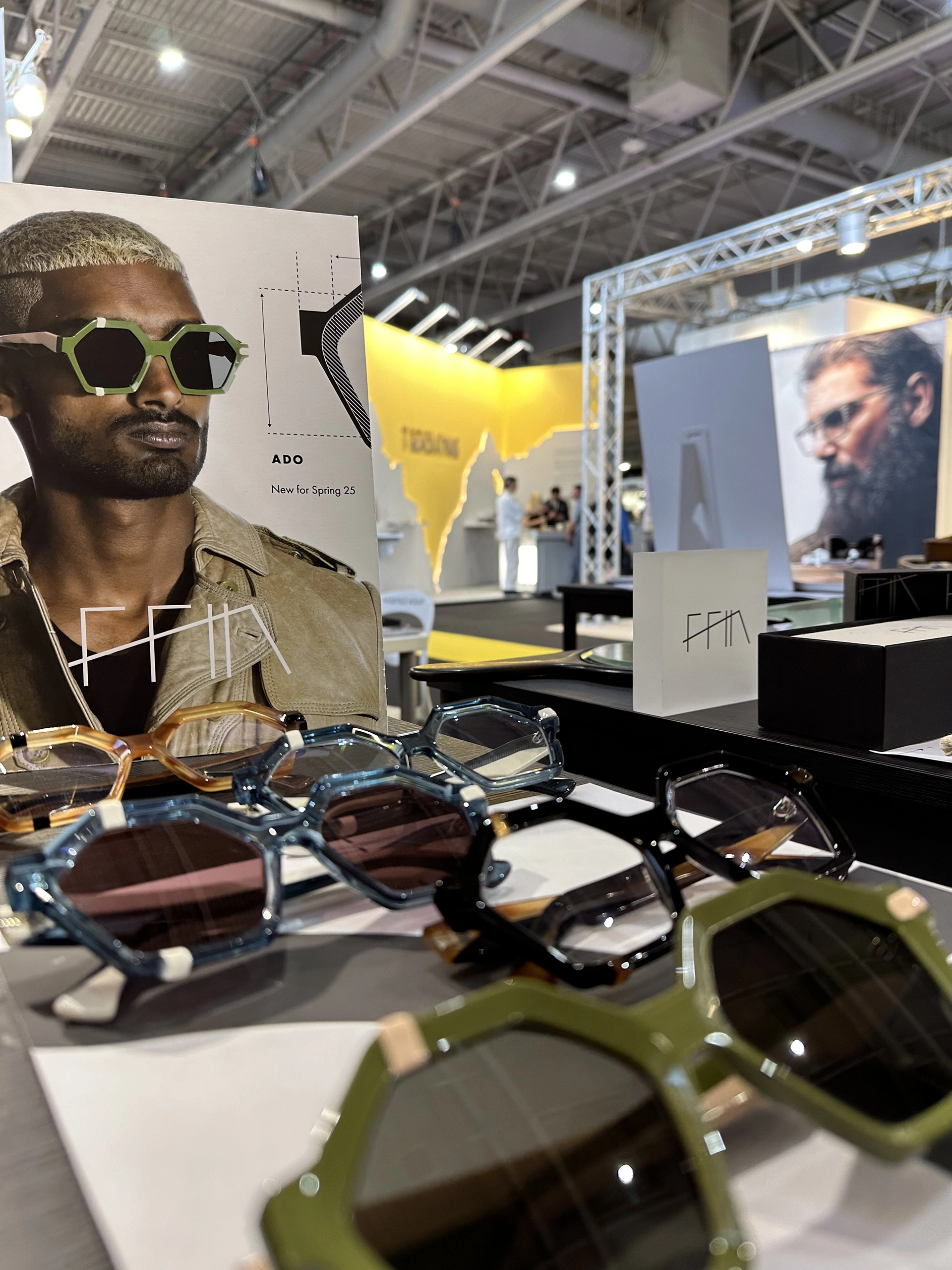 Ffin stand at SILMO with hexagonal designer sunglasses on display before portrait prints