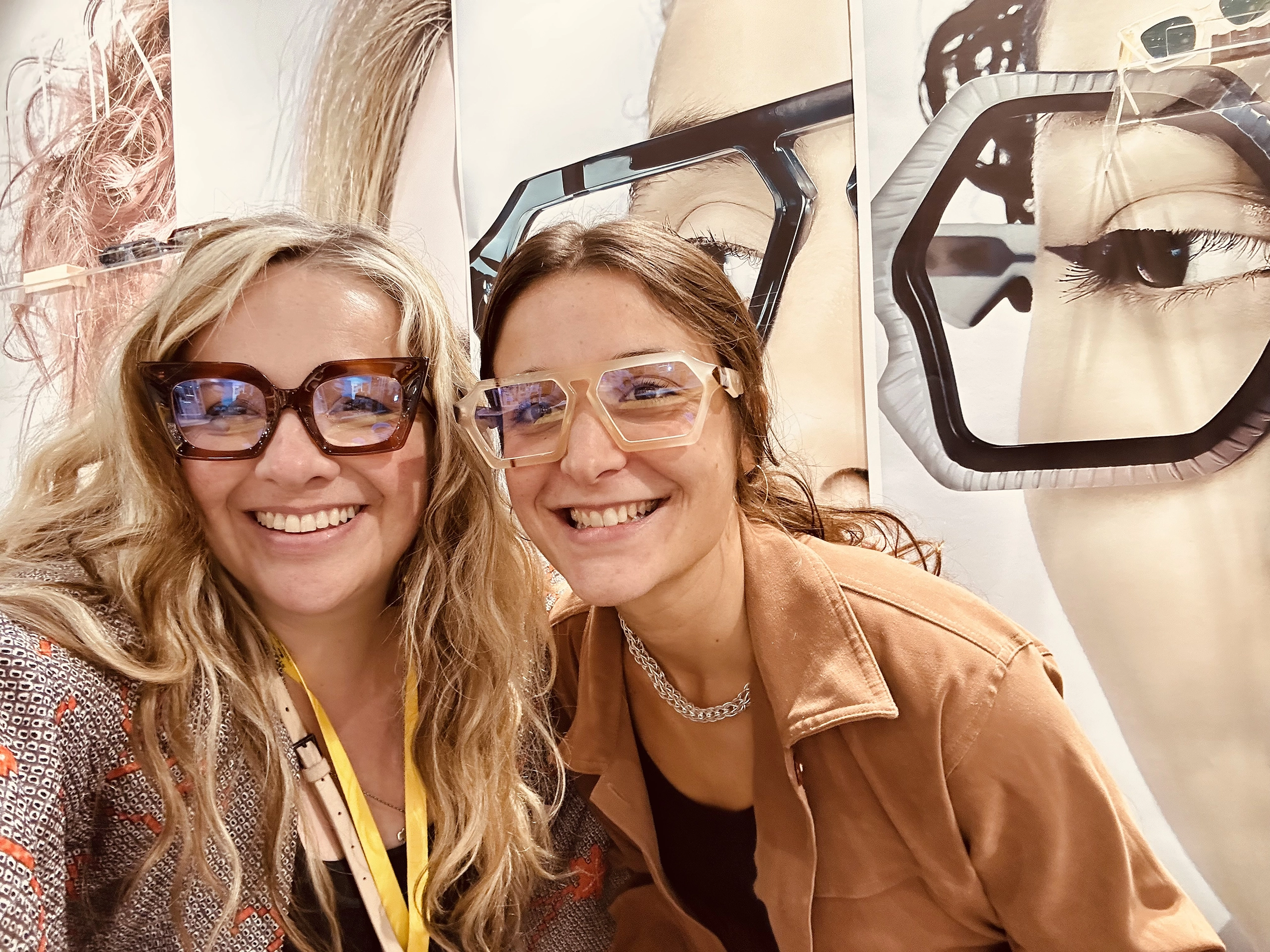 Two smiling team members in Ffin optical frames at the Ffin stand at SILMO