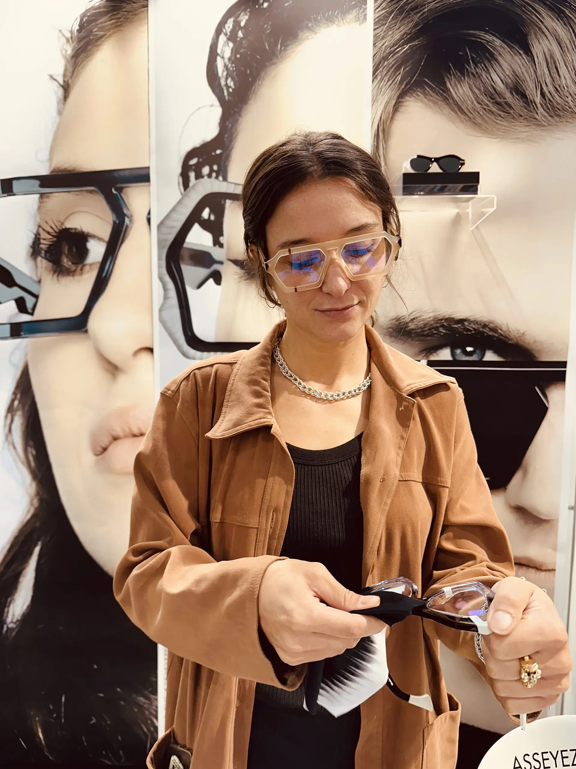 Ffin team member at SILMO Paris examining a pair of Ffin optical frames